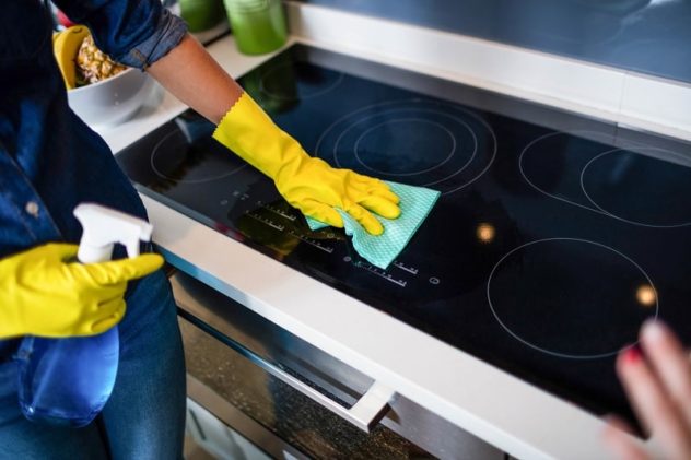 Woman Cleaning Induction Hob