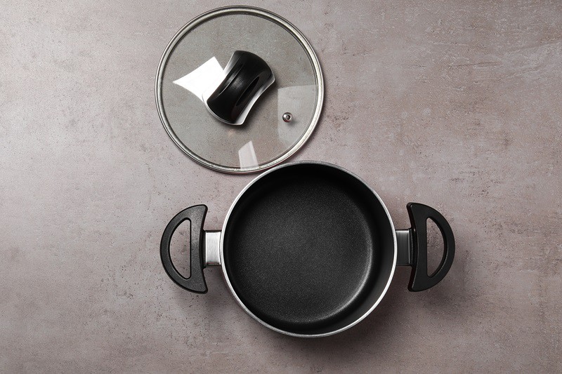 Saucepan with plastic handles