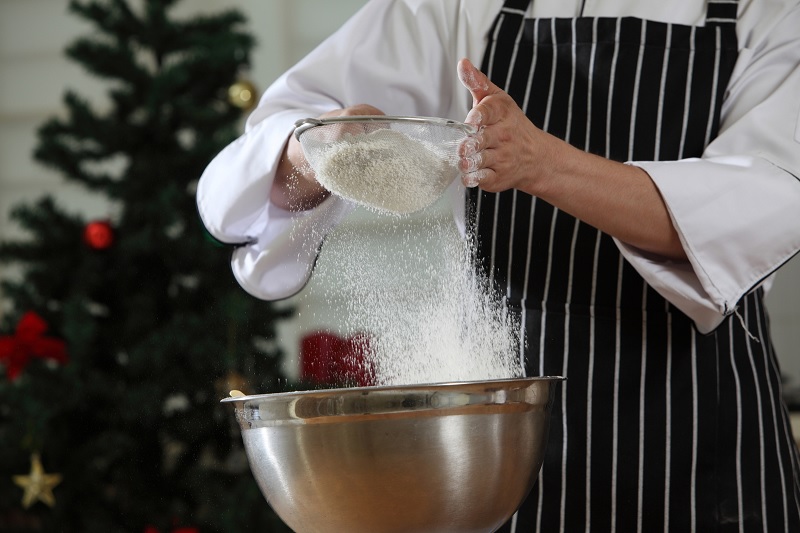 Chef sieving caster sugar