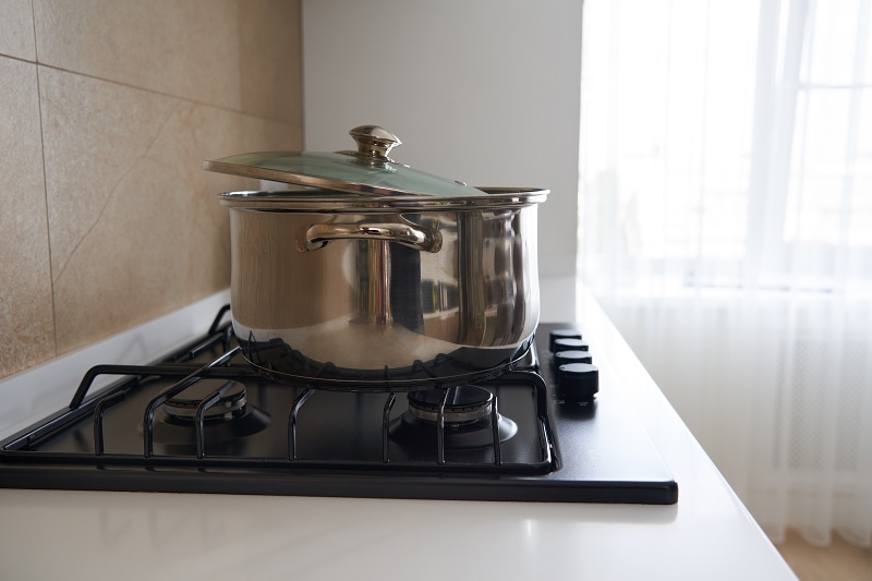 Stainless steel pan on gas hob