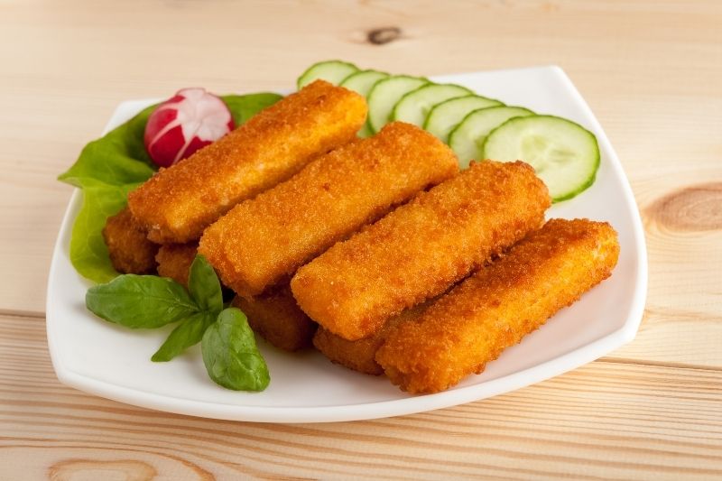 Fish fingers in the plate with side dish