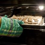 Taking biscuits out of oven with gloves