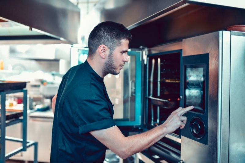 man operating the oven