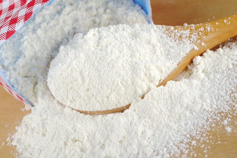 Flour on wooden spoon