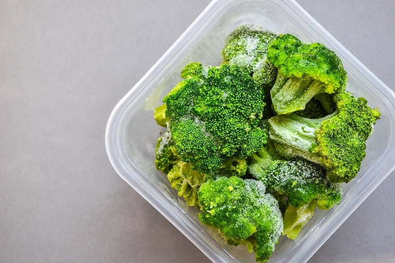 Frozen broccoli in plastic container