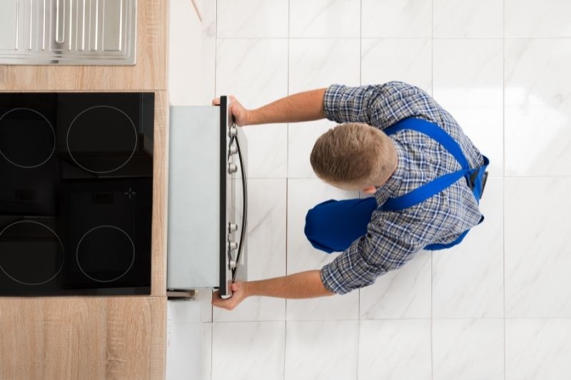 man moving the oven