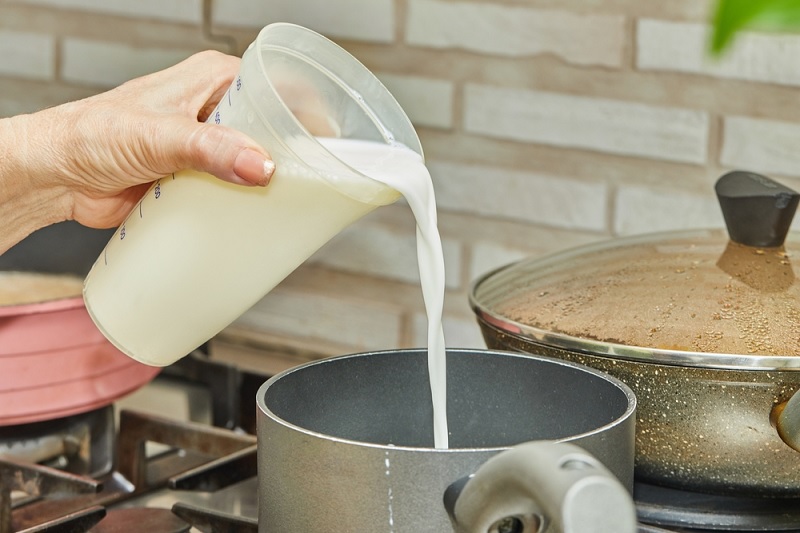 Pouring milk into pan