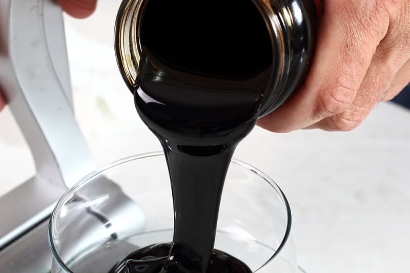 Pouring molasses from jar