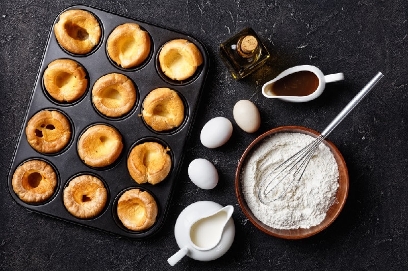 Yorkshire puddings on baking tray with ingredients