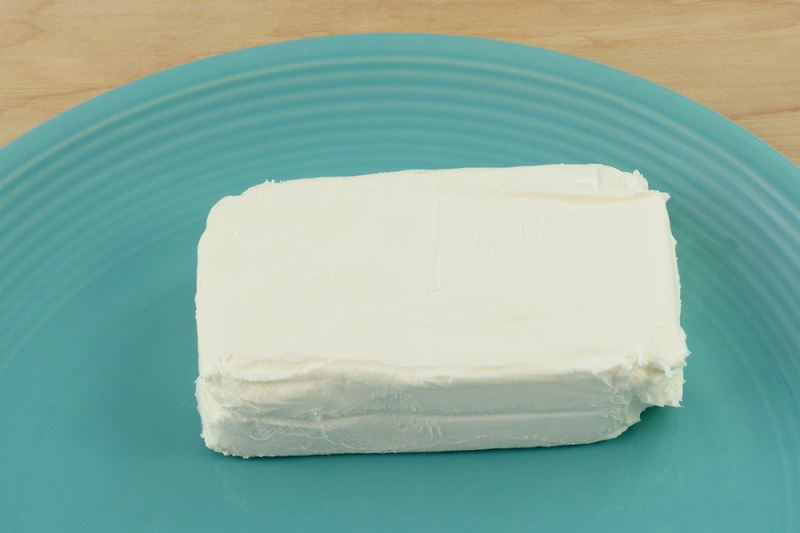 Block of American cream cheese on plate