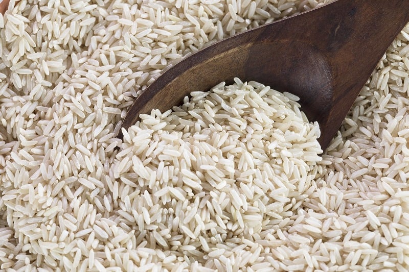 Spoon in uncooked brown rice