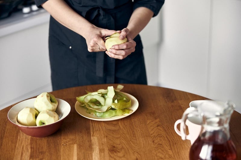 Woman peeling apples