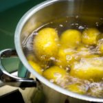 Potatoes boiling in pan