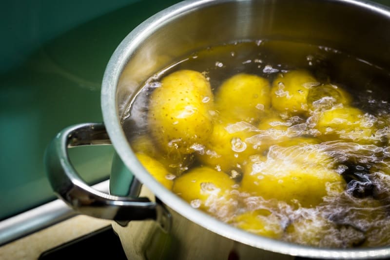 Potatoes boiling in pan