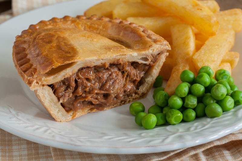 Steak pie with chips and peas