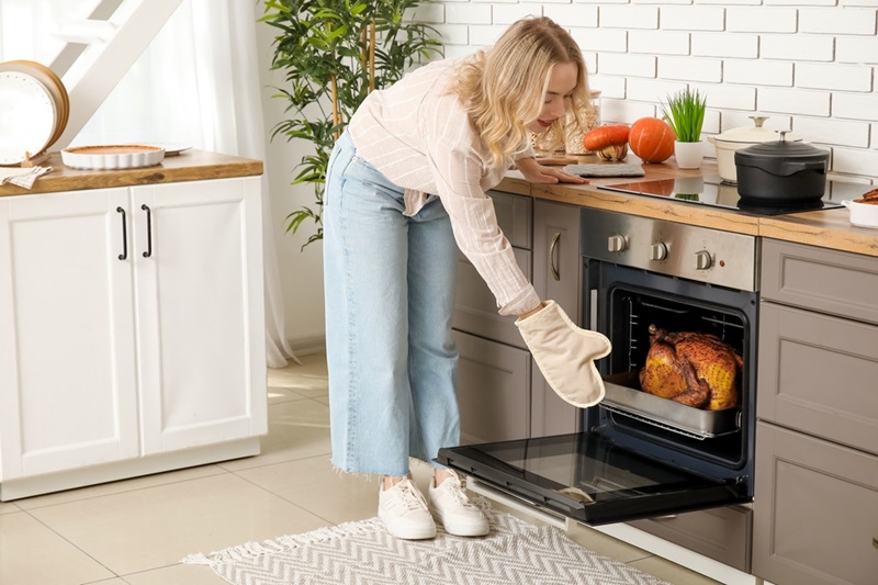 Woman using oven gloves